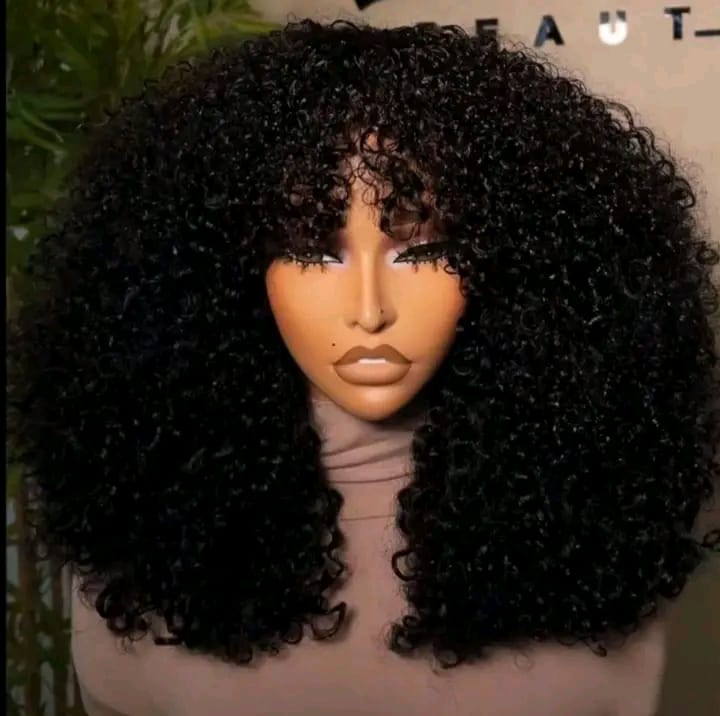 a human hair style featuring voluminous curls and a fringe.